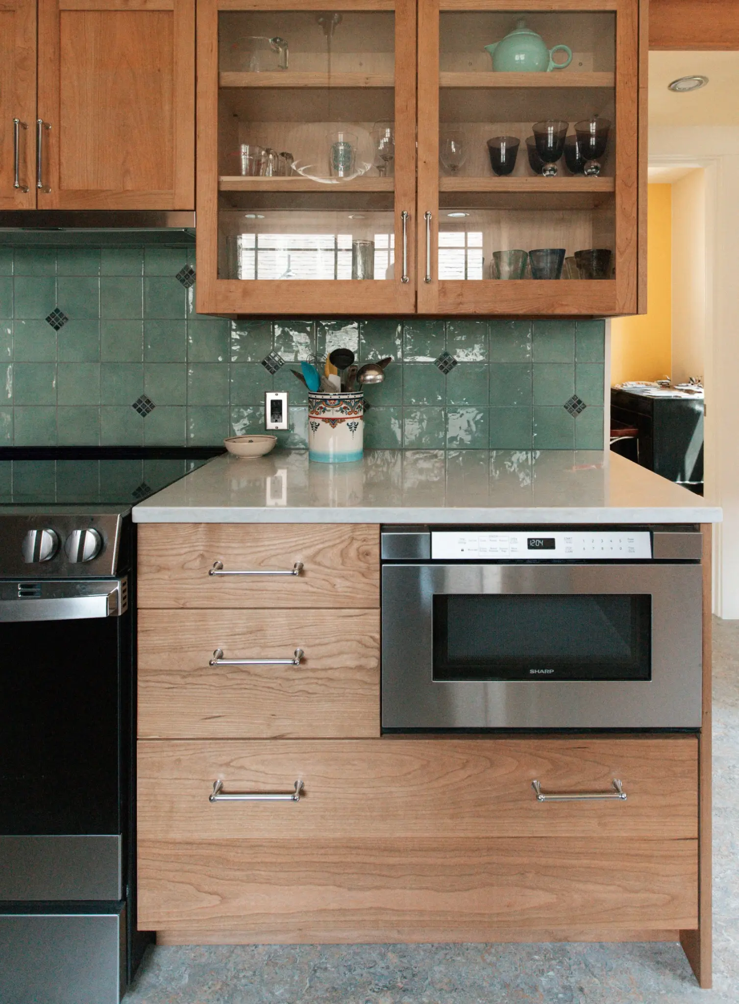 Completed appliance wall and glass-front cabinetry