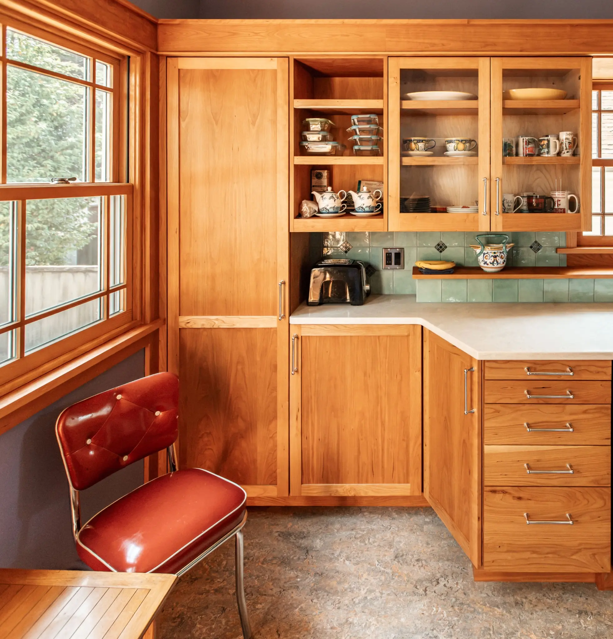 Custom cabinetry beside the kitchen windows
