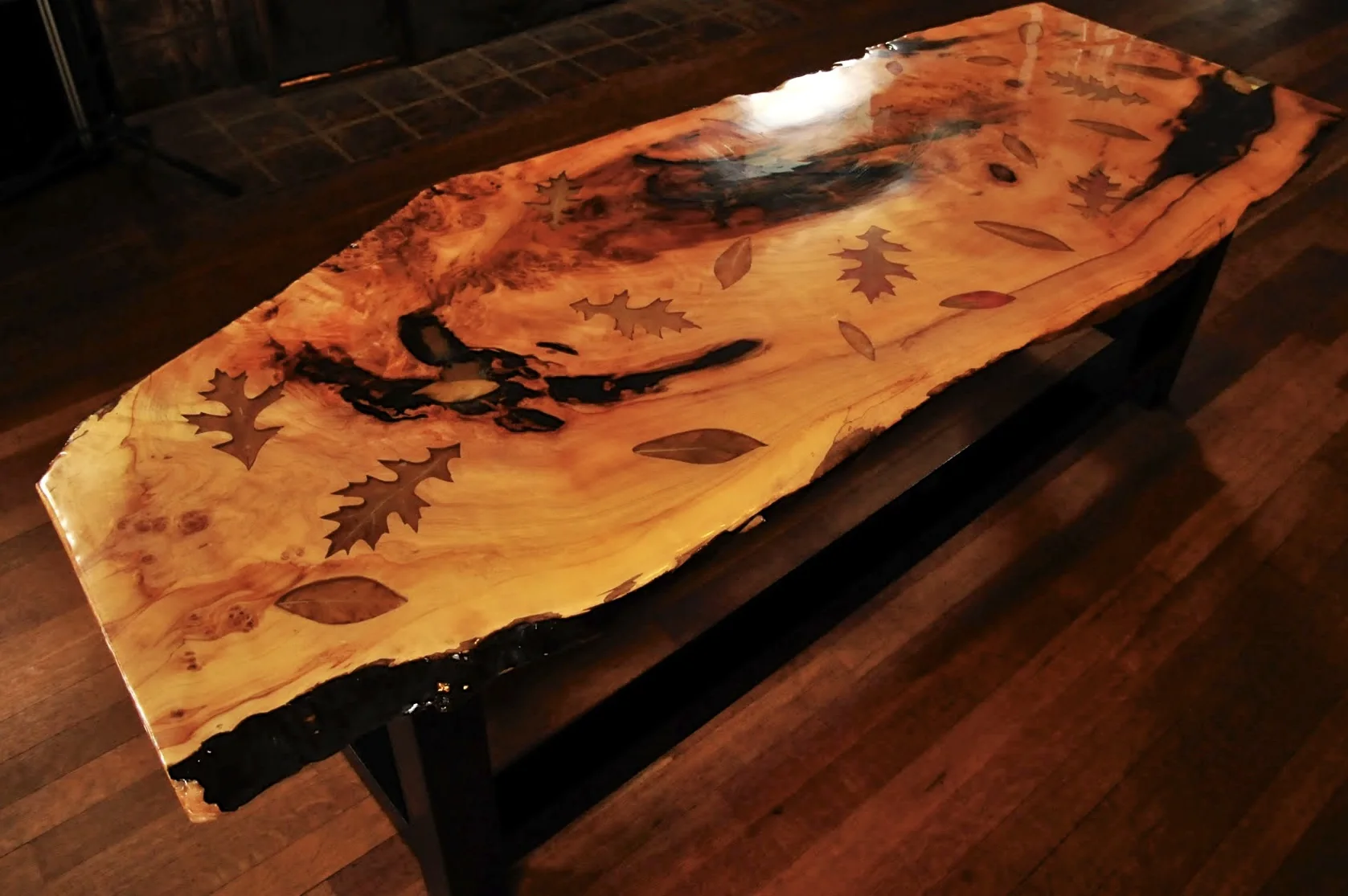 Completed live-edge table with hand-carved autumn leaves