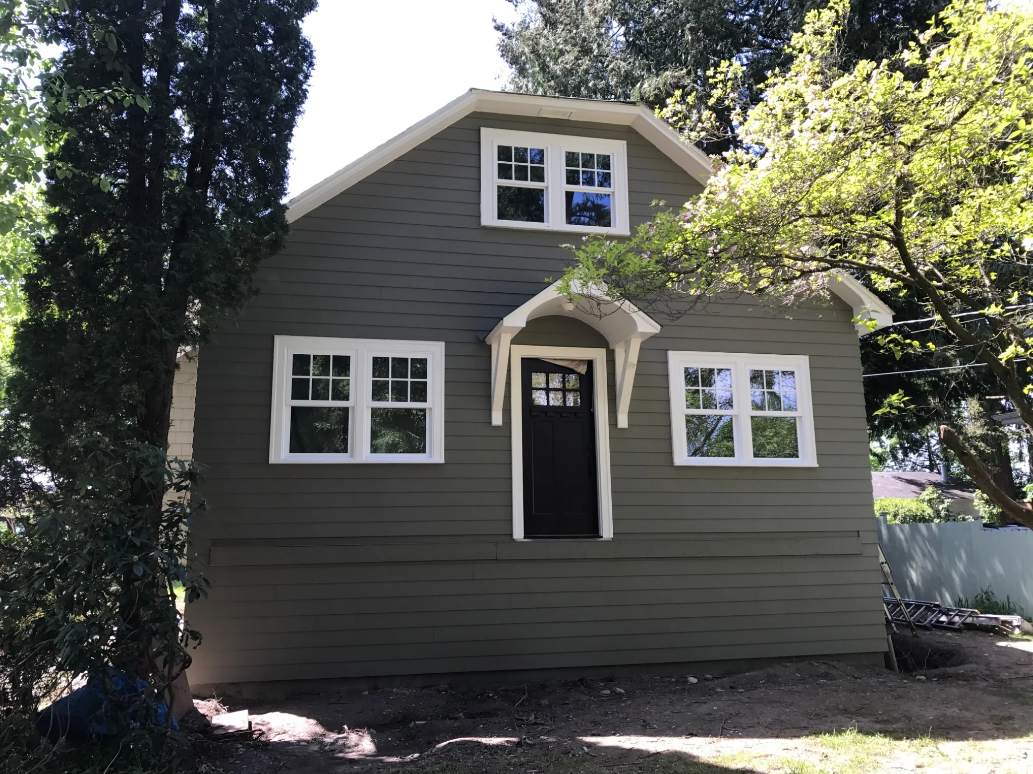 New siding, windows, and trim before the porch work