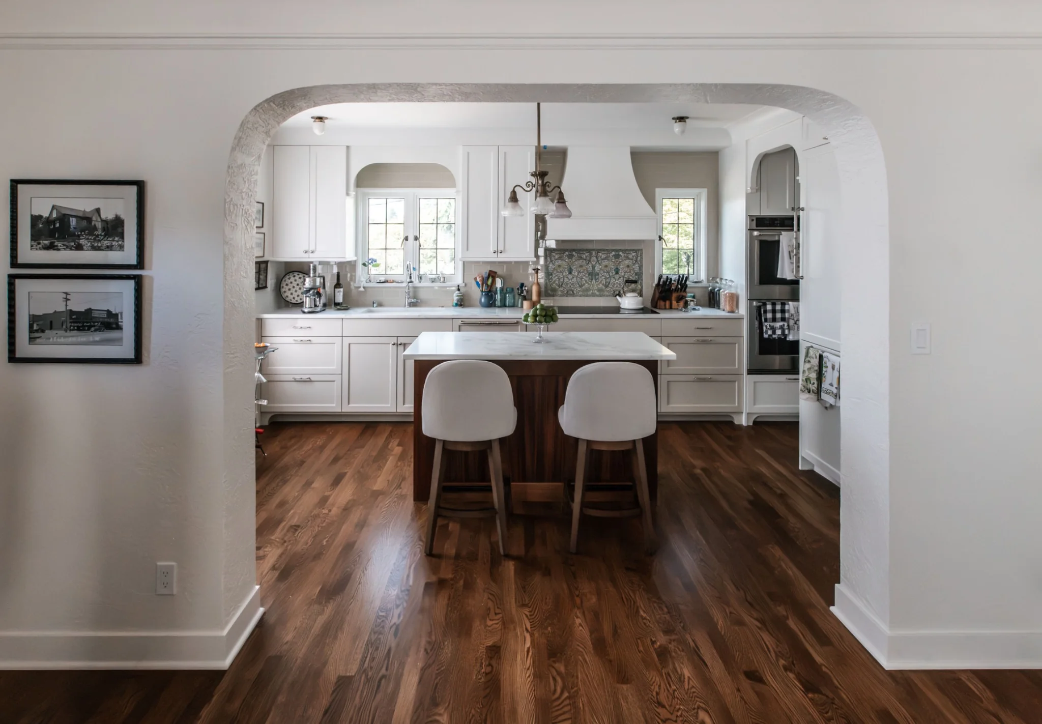 Completed 1929 Tudor kitchen viewed through a restored plaster arch