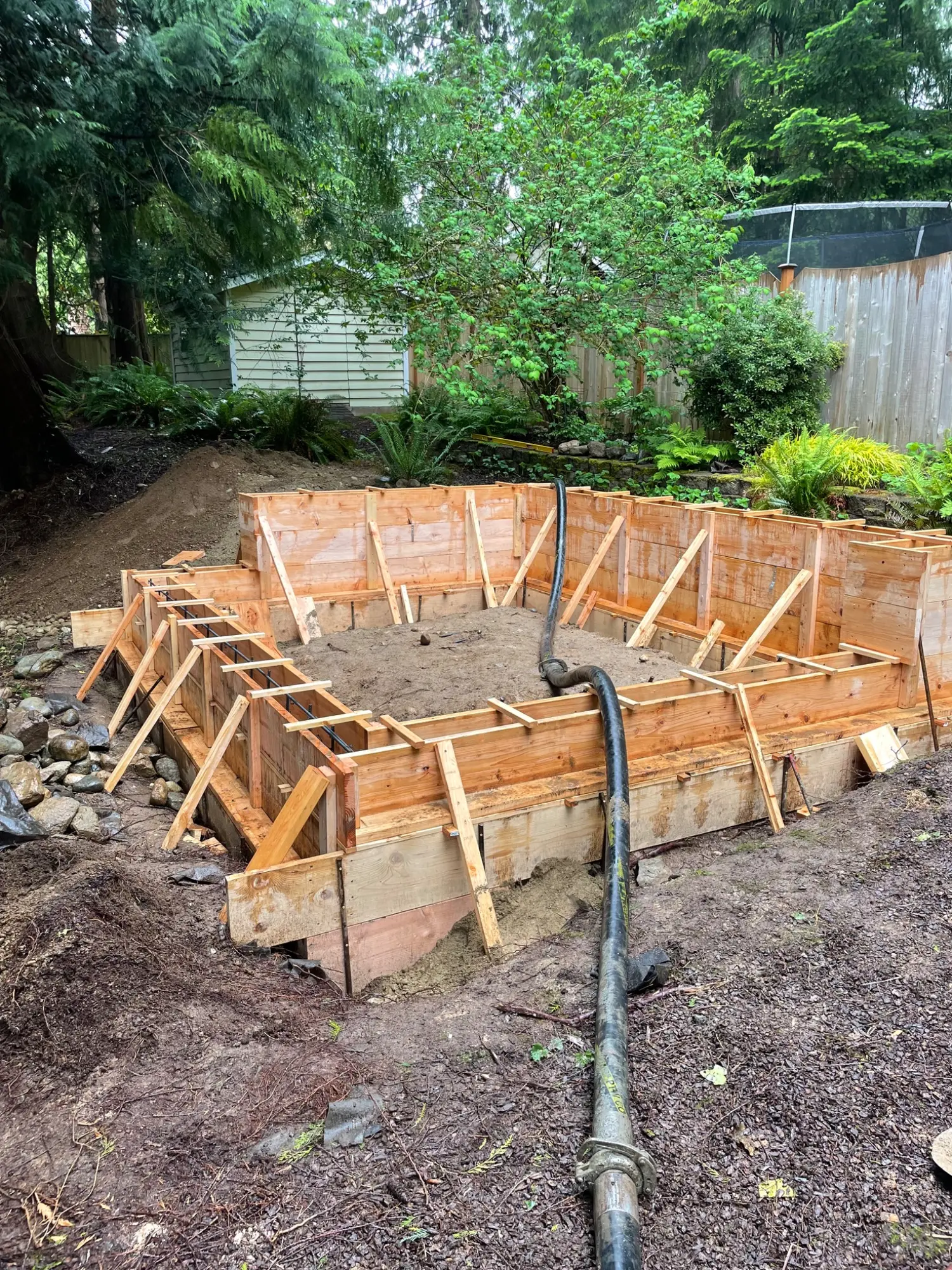 Concrete foundation forms on the sloped site